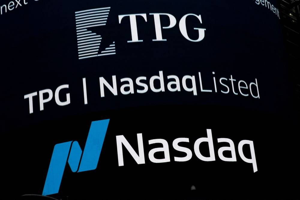 A screen announces the listing of Private-equity firm TPG, during the IPO at the Nasdaq Market site in Times Square in New York City January 13, 2022. — Reuters pic
