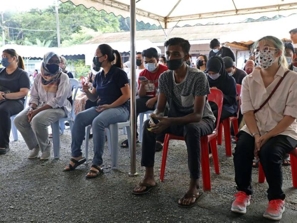 Young voters waiting their turn to cast their votes at a polling station in Tambun, Perak, on November 19, 2022. — TODAY pic