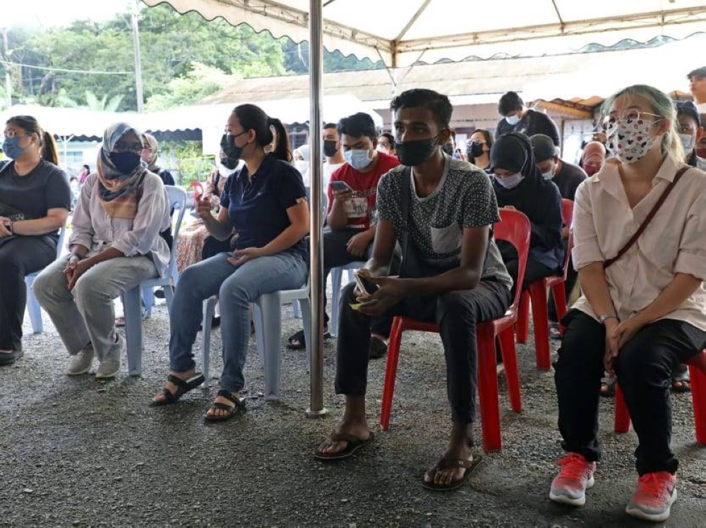 Young voters waiting their turn to cast their votes at a polling station in Tambun, Perak, on November 19, 2022.  — TODAY pic