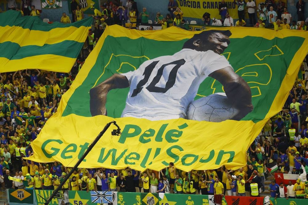 Brazil fans display a banner with an image of former player Pele on it before the Group G match between Brazil and Cameroon at the Lusail Stadium in Lusail, Qatar, December 2, 2022. — Reuters pic