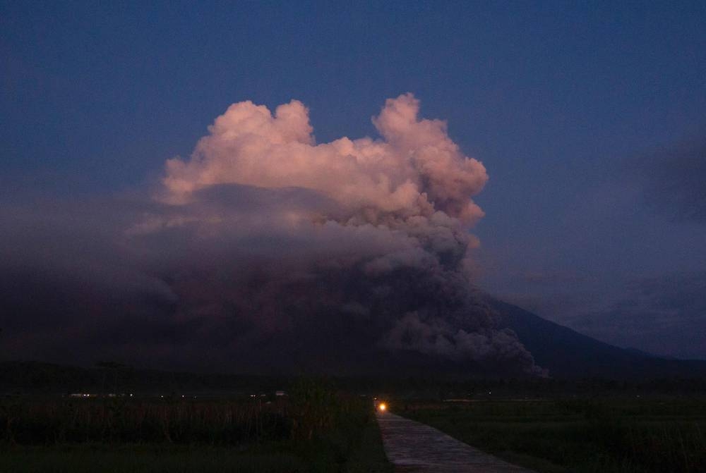 Mount Semeru spews smoke and ash in Lumajang on December 4, 2022. — AFP pic