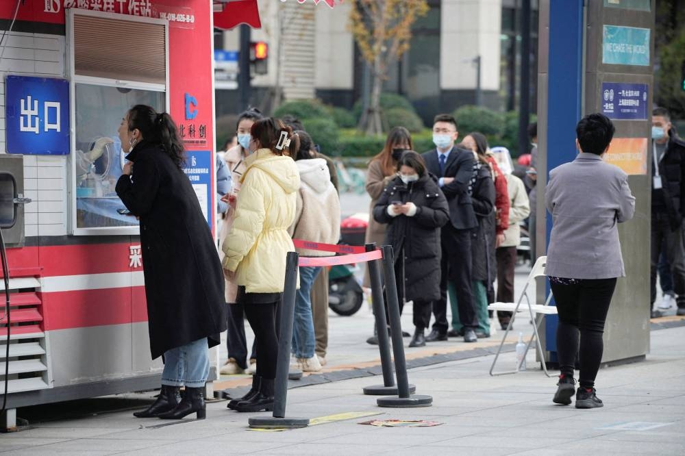 A woman gets tested at a Covid-19 testing site in Shanghai, China December 5, 2022. ― Reuters pic