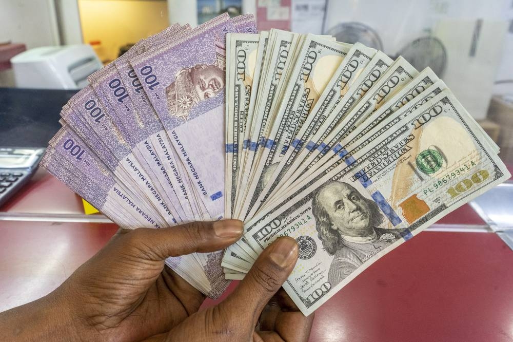 At 9.02am, the local note slipped to 4.3780/3830 against the US dollar from 4.3660/3715 at yesterday's close. — Picture by Shafwan Zaidon