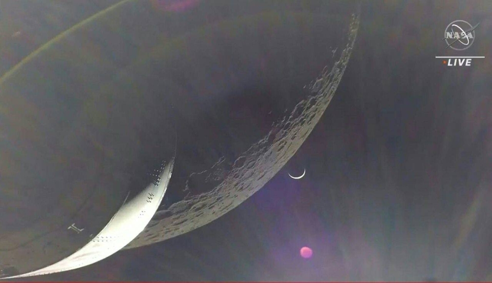 In this handout video grab courtesy of Nasa TV, the Earth is visible as a crescent in the minutes after Orion finished its engine burn around the moon, December 5, 2022. Nasa TV handout pic via AFP 