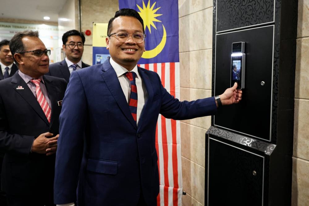 Nik Nazmi Nik Ahmad clocks in on his first day of work as Minister of Natural Resources, Environment and Climate Change at Wisma Sumber Asli, Putrajaya December 5, 2022. — Bernama pic