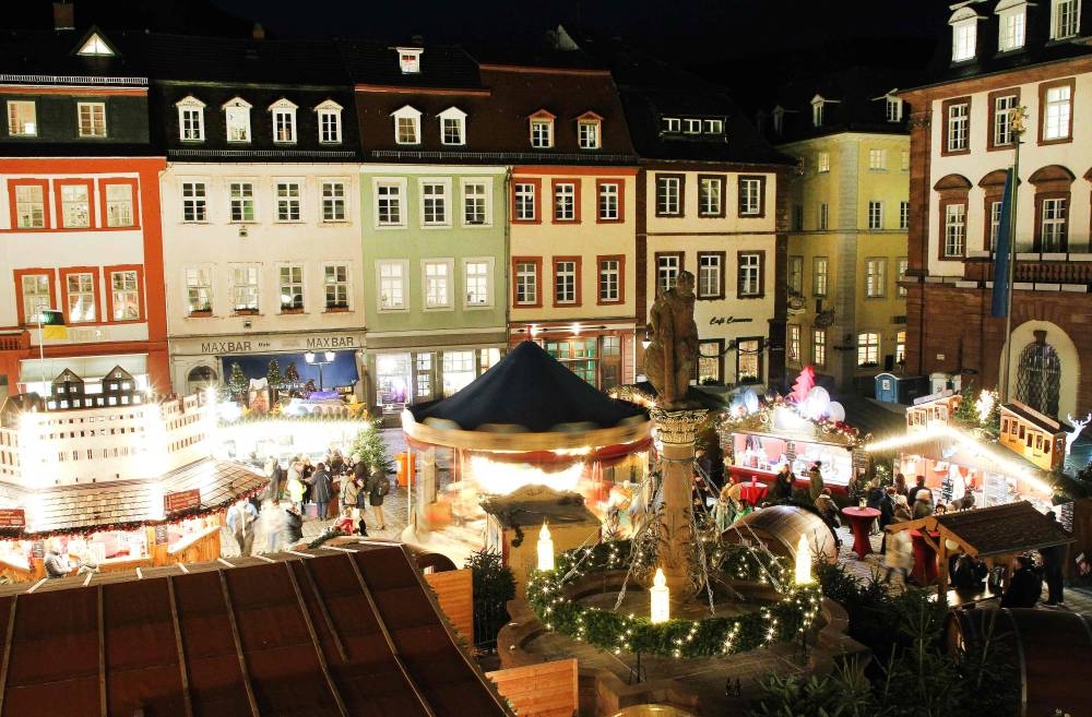 A general view shows a Christmas Market with lights decorations, booths and carousels in Heidelberg, Germany, on December 6, 2022. One in two Germans say they now only spend on essential items, according to a survey by EY consultancy. — AFP pic