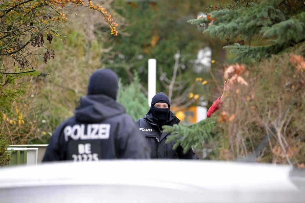 Police officers are seen during a raid on December 7, 2022 in Berlin that is part of nationwide early morning raids against members of a far-right 