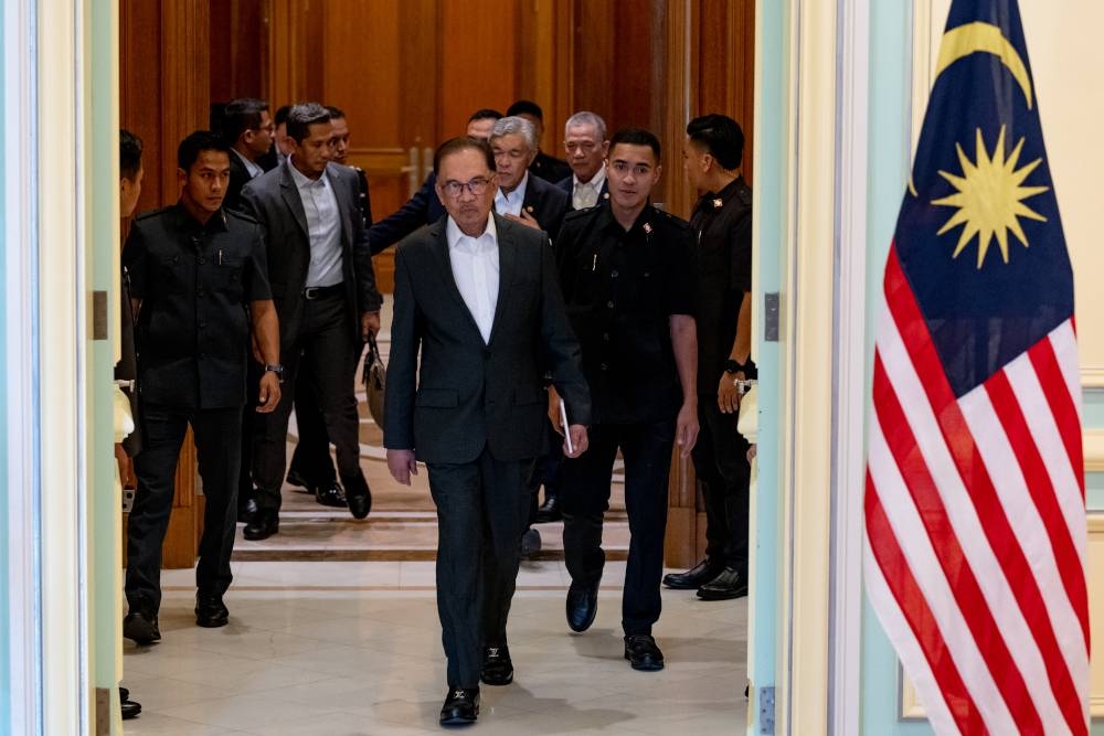 Prime Minister Datuk Seri Anwar Ibrahim arrives at a press conference after chairing the first special Cabinet meeting in Putrajaya, December 5, 2022. — Picture courtesy of Afiq Hambali/Prime Minister’s Office of Malaysia