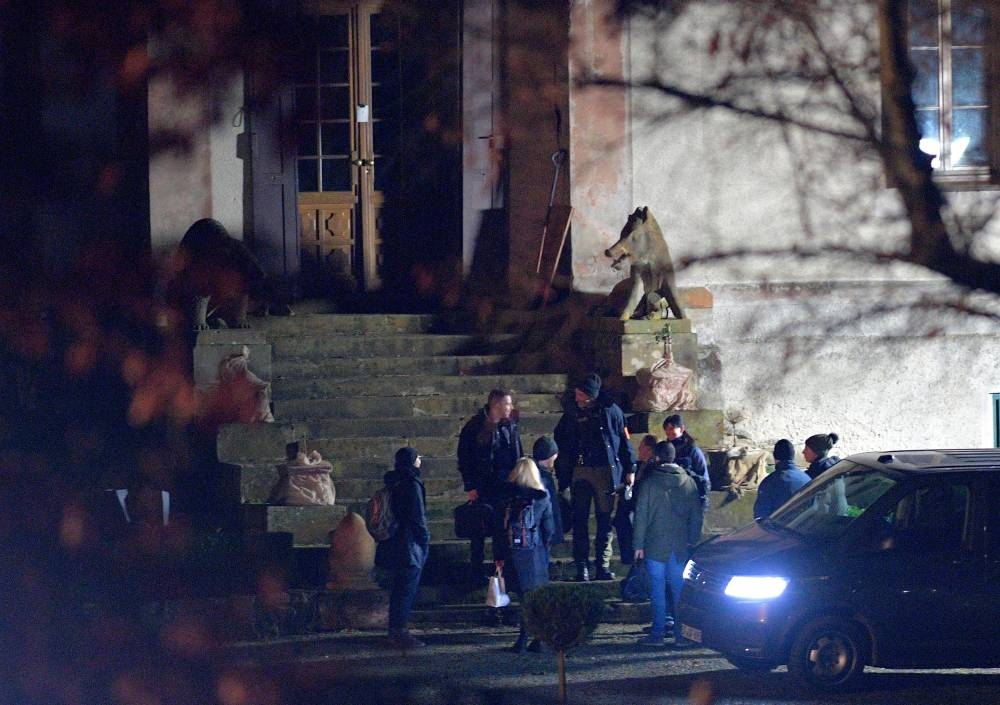 Officials leave the hunting lodge Waidmannsheil after 25 suspected members and supporters of a far-right group were detained during raids across Germany, in Bad Lobenstein-Saaldorf, December 7, 2022. — Reuters pic 