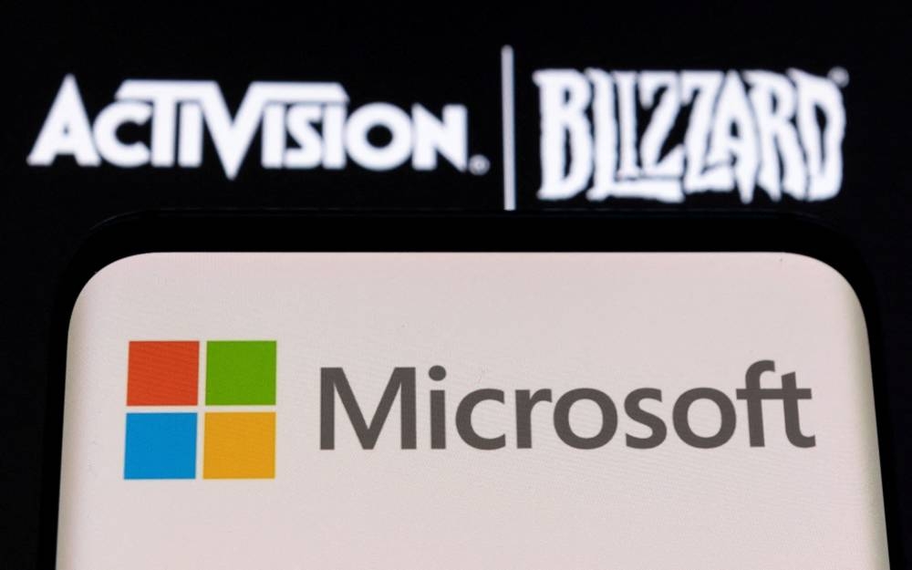 Microsoft logo is seen on a smartphone placed on displayed Activision Blizzard logo in this illustration taken January 18, 2022. — Reuters pic