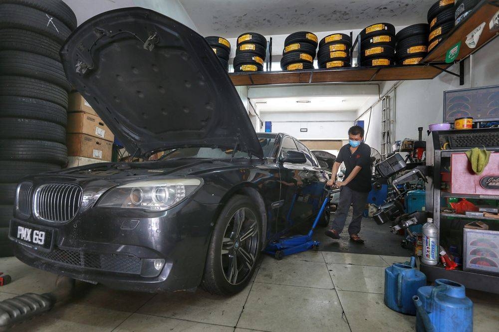 A mechanic repairs a car at his workshop in Kuala Lumpur April 14, 2020. ― Picture by Ahmad Zamzahuri