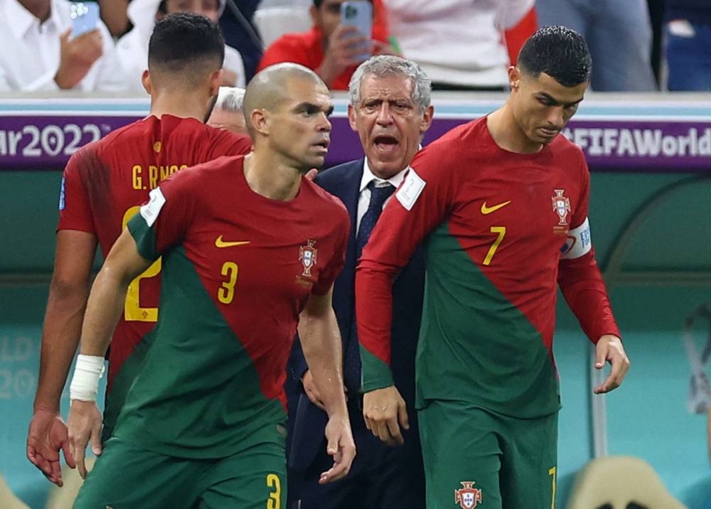 Portugal's Cristiano Ronaldo with Pepe and coach Fernando Santos (centre) as he comes on as a substitute against Switzerland at the Lusail Stadium December 6, 2022. ― Reuters pic