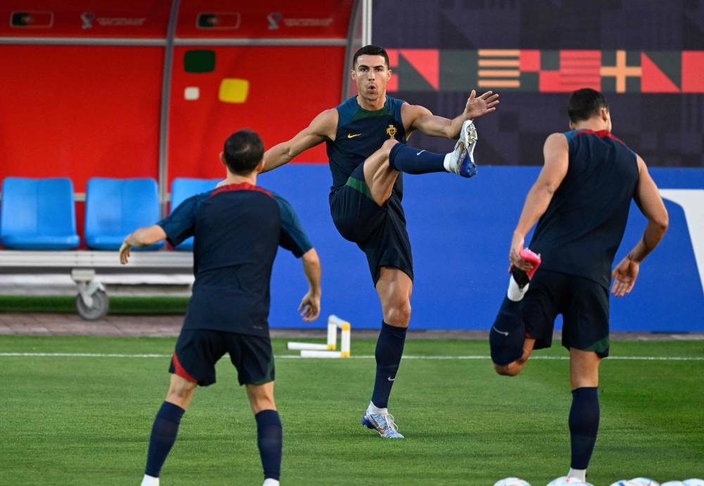Portugal’s forward #07 Cristiano Ronaldo (centre) and his teammates take part in a training session at the Al Shahaniya SC training site, northwest of Doha on December 9, 2022, on the eve of the Qatar 2022 World Cup quarter-final football match between Morocco and Portugal. — Reuters pic