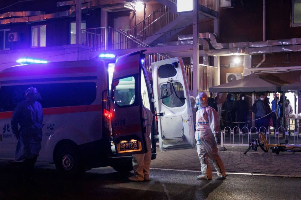 A medic wears personal protection gear as he stands besides an ambulance outside a fever clinic at a hospital as coronavirus disease (COVID-19) outbreaks continue in Beijing, China December 9, 2022. — Reuters pic