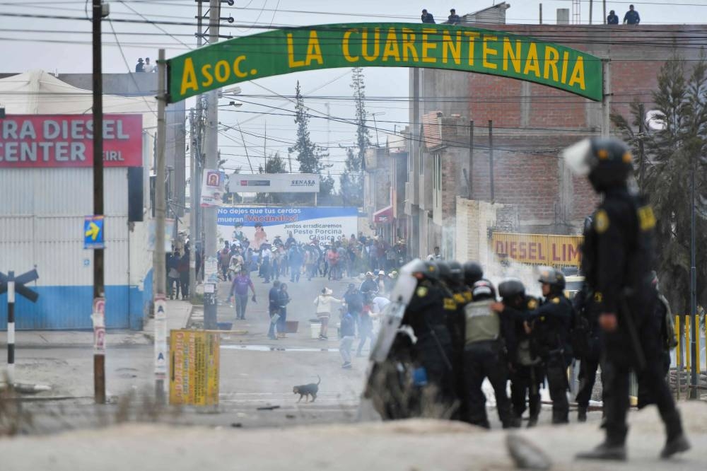 Demonstrators clash with riot police during a protest on the Pan-American highway in the Northern Cone of Arequipa, Peru December 12, 2022. — AFP pic