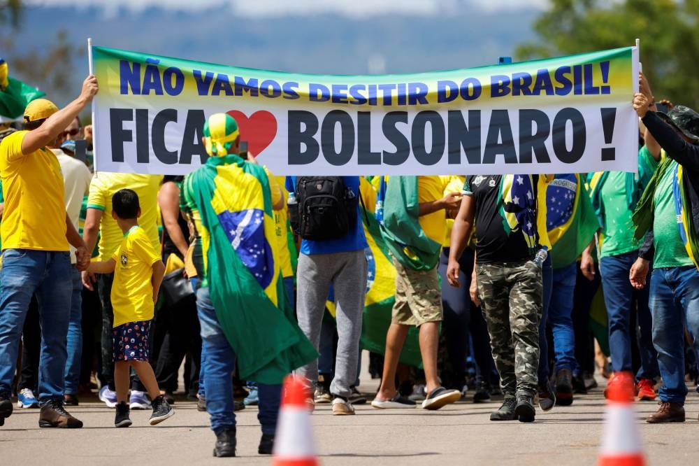 Supporters of Brazil's President Jair Bolsonaro take part in a protest against Brazilian President-elect Luiz Inacio Lula da Silva at the Alvorada Palace, in Brasilia December 12, 2022. — Reuters pic