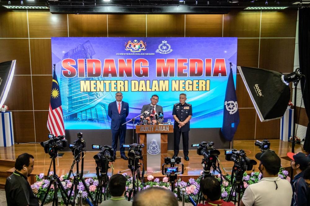 Home Minister Datuk Seri Saifuddin Nasution Ismail (centre) speaks during a press conference at Bukit Aman in Kuala Lumpur December 13, 2022. — Picture by Firdaus Latif
