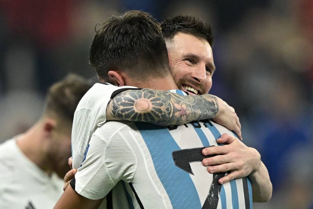 Argentina's Lionel Messi celebrates with Paulo Dybala after defeating Croatia 3-0 in the Qatar 2022 World Cup football semi-final at the Lusail Stadium in Lusail December 13, 2022. — AFP pic