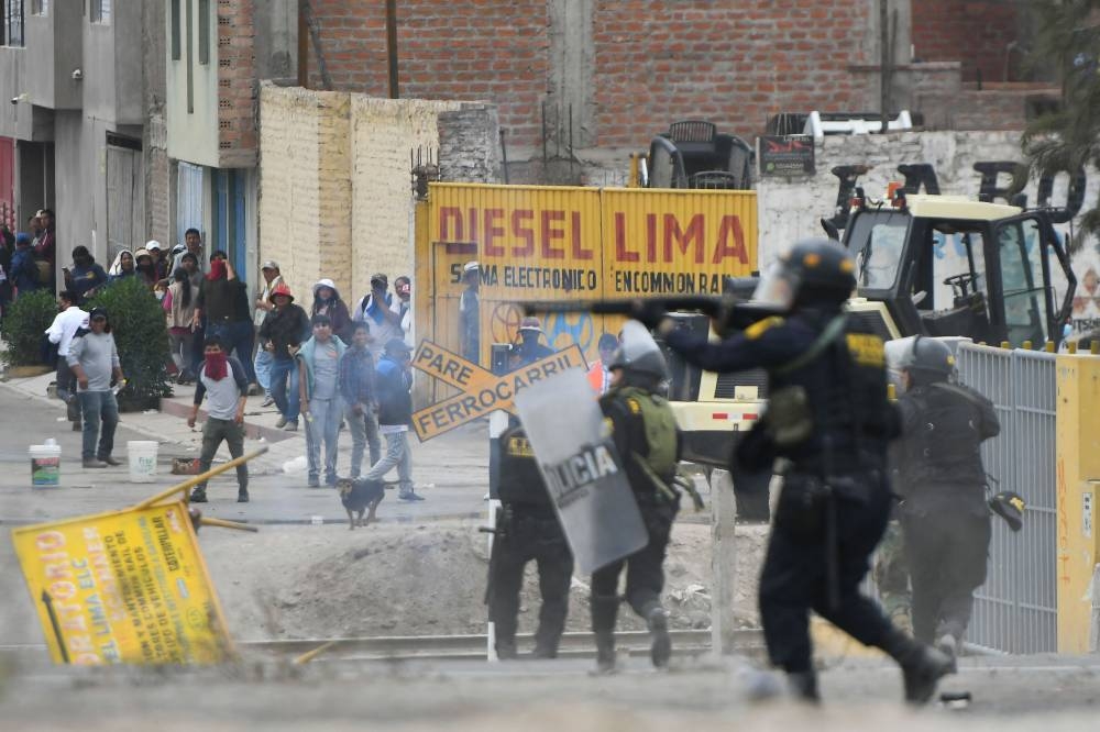 Demonstrators clash with riot police during a protest on the Pan-American highway in the Northern Cone of Arequipa, Peru, on December 12, 2022. — AFP pic
