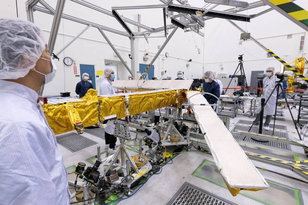 Members of the international Surface Water and Ocean Topography radar satellite mission test one of the antennas for the Ka-band Radar Interferometer instrument in a clean room at Nasa's Jet Propulsion Laboratory in Pasadena, California in 2022. — Picture courtesy of Nasa/JPL-Caltech/Handout via Reuters