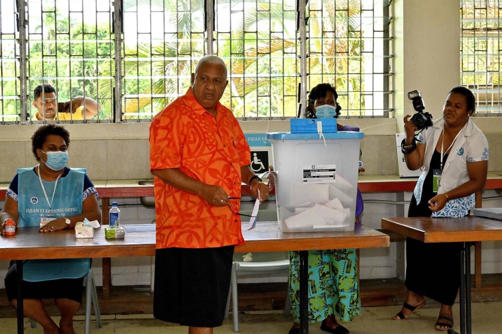 Fiji Prime Minister Frank Bainimarama casts his vote at Yat Sen Secondary School polling station during the general elections in Fiji capital city Suva December 14, 2022. — AFP pic