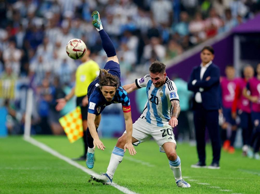 Croatia’s Luka Modric in action with Argentina’s Alexis Mac Allister at Lusail Stadium, Lusail, Qatar, December 13, 2022. — Reuters pic    