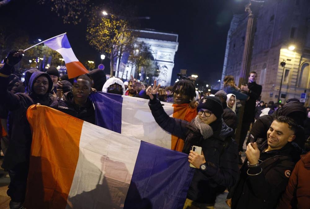 France fans celebrate on the Champs-Elysees after the match against Morocco in Paris December 14, 2022. — Reuters pic