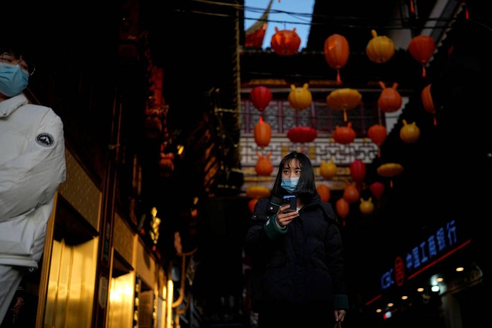 A woman wearing a face mask walks at the Yu Garden, as Covid-19 outbreaks continue in Shanghai, China, December 14, 2022. — Reuters pic