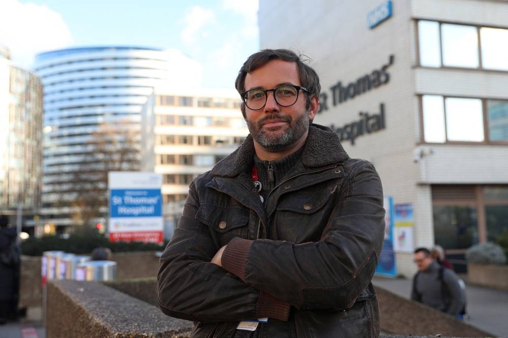 Nurse Mark Boothroyd, a RCN (Royal College of Nursing) member and a Unite union rep, poses for a photograph outside of Guy's and St Thomas' Hospital in central London on December 6, 2022. — AFP pic