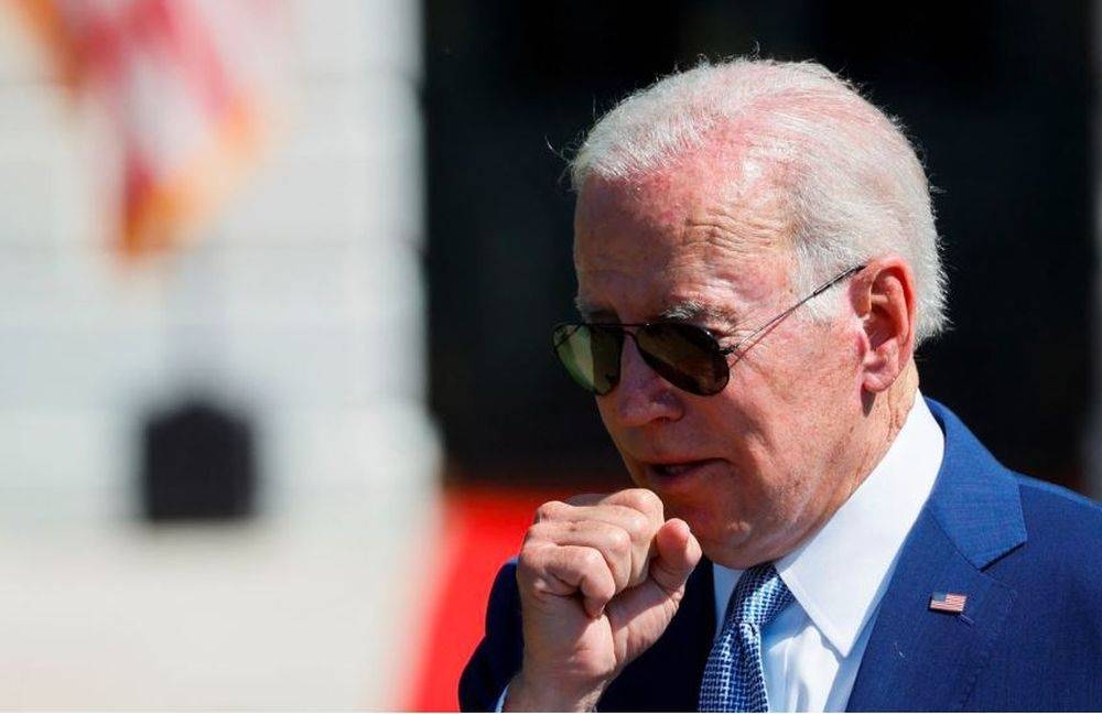US President Joe Biden coughs during a signing event for the CHIPS and Science Act of 2022, on the South Lawn of the White House in Washington, US, August 9, 2022. — Reuters pic