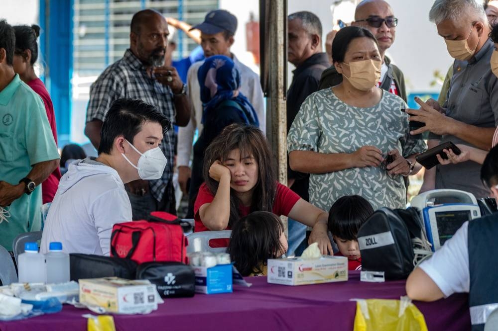 Victims rescued from the landslide at the Father’s Organic Farm campsite in Batang Kali are pictured at the Hulu Yam Bharu police station in Hulu Selangor December 16, 2022. — Picture by Firdaus Latif