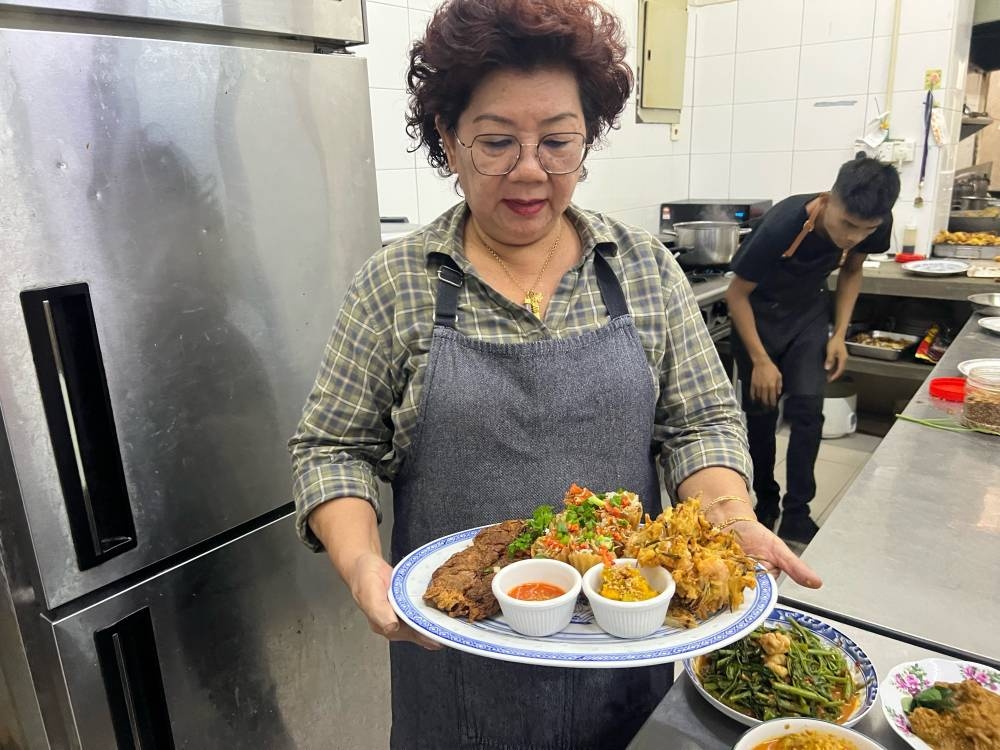 Beh Gaik Lean with some of her specialty dishes: ‘lor bak’, ‘pie tie’ and prawn fritters. — Picture by Opalyn Mok 