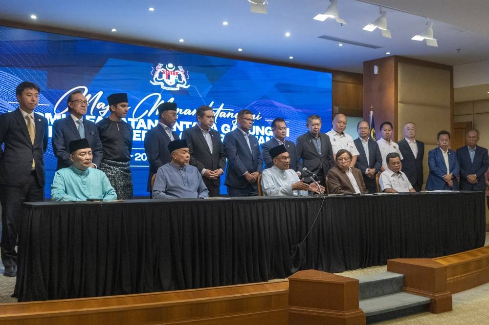 Datuk Seri Anwar Ibrahim speaks to the media during the national unity government MoU signing ceremony at Perdana Putra in Putrajaya, December 16, 2022. — Picture by Shafwan Zaidon