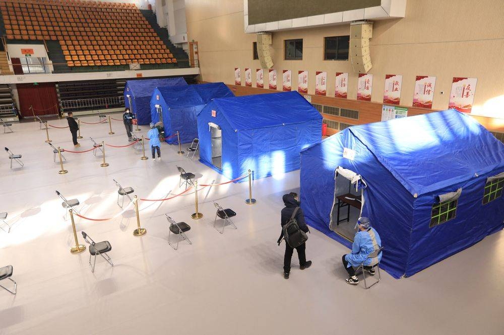 People line up at a makeshift fever clinic set up inside a stadium, amid the coronavirus disease (Covid-19) outbreak in Beijing, China December 14, 2022. — China Daily pic via Reuters