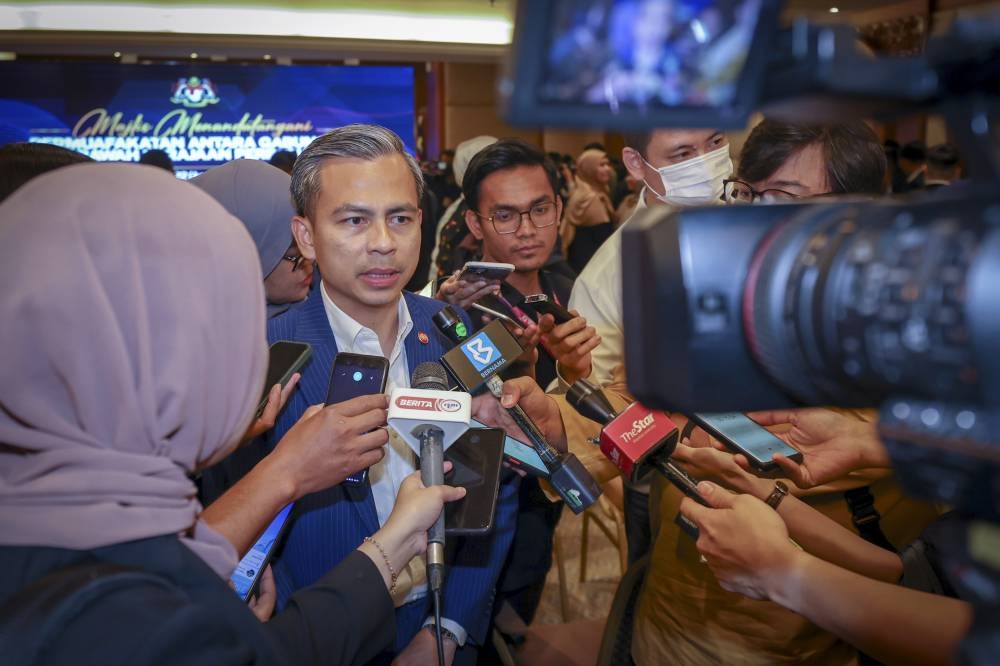 Communications and Digital Minister Fahmi Fadzil speaks to reporters after witnessing the unity government MoU signing ceremony at Perdana Putra in Putrajaya, December 16, 2022. — Bernama pic 