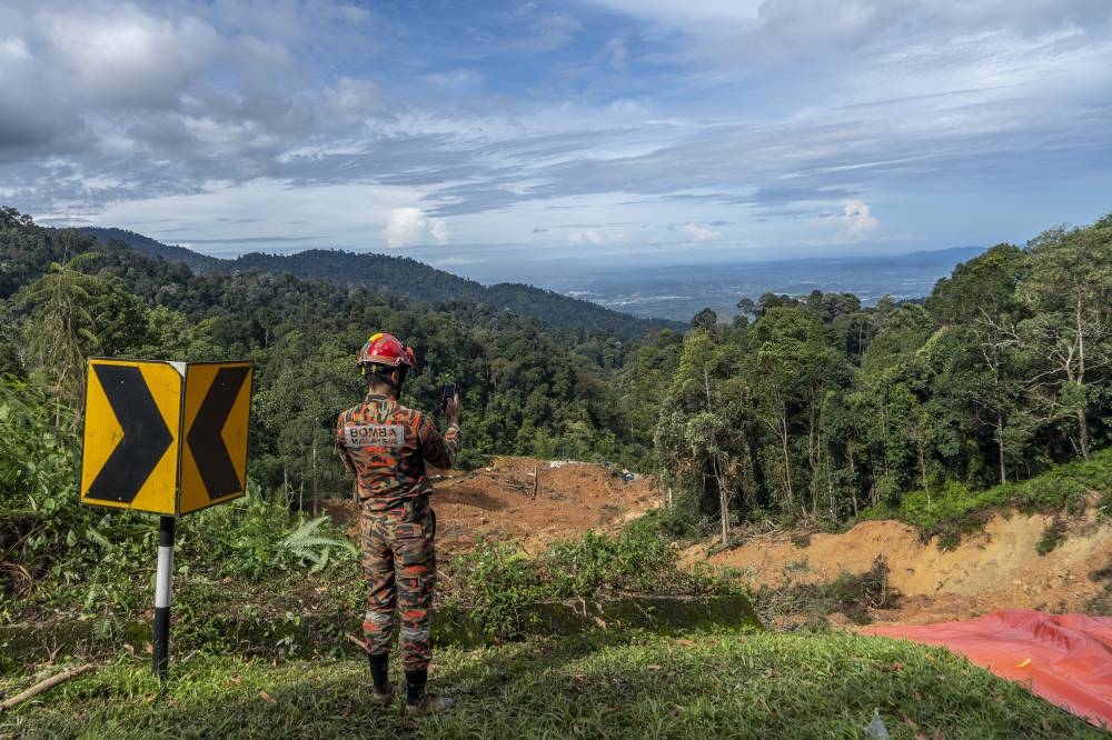 Rescue personnel work at the site of a landslide at the Father's Organic Farm campsite in Batang Kali December 17, 2022. ― Picture by Shafwan Zaidon