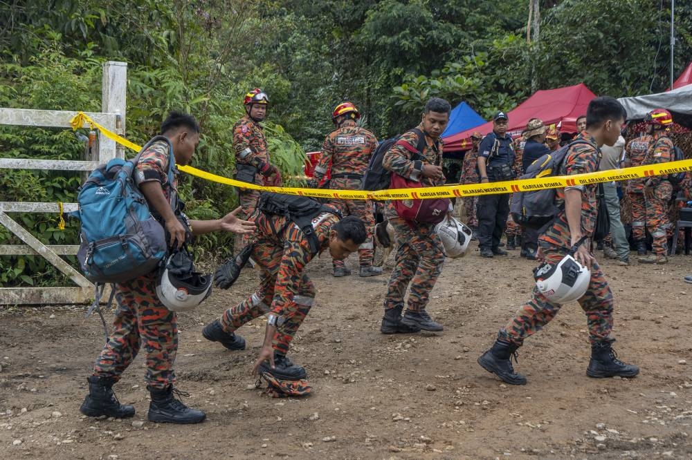 Search and rescue personnel work at the site of a landslide at the Father's Organic Farm campsite in Batang Kali December 17, 2022. ― Picture by Shafwan Zaidon