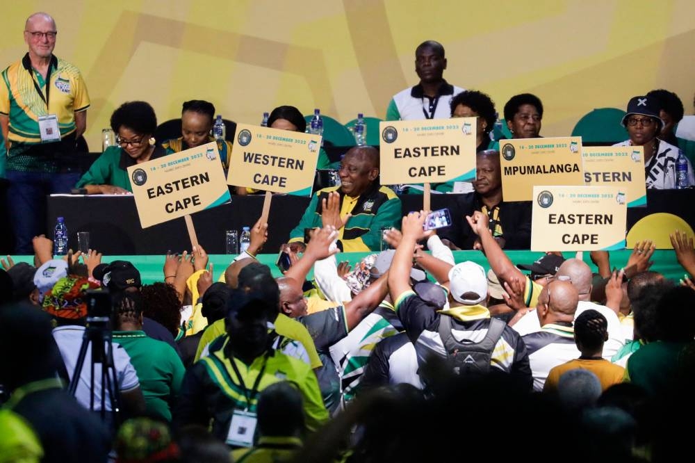 South African and African National Congress (ANC) President Cyril Ramaphosa (centre) smiles during the first plenary session during the 55th National Conference of the ANC at the  National Recreation Center (NASREC) in Johannesburg on December 16, 2022. — AFP pic