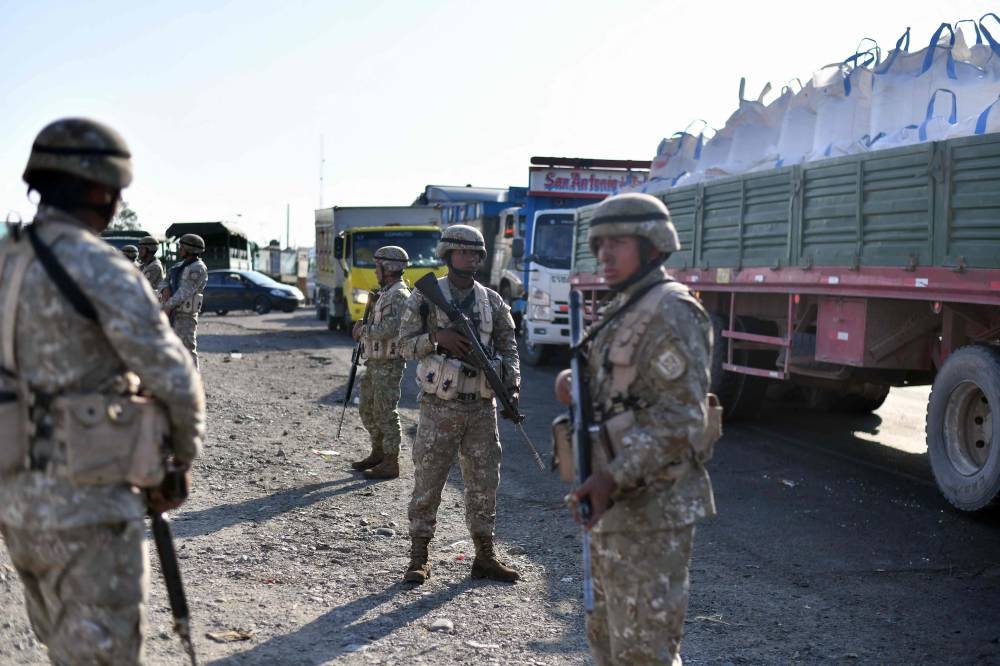 Soldiers stand guard on the Pan-American highway in the town of Alto Siguas, in the Majes district, province of Cailloma, in the Arequipa region, southern Peru, on December 17, 2022. — AFP pic