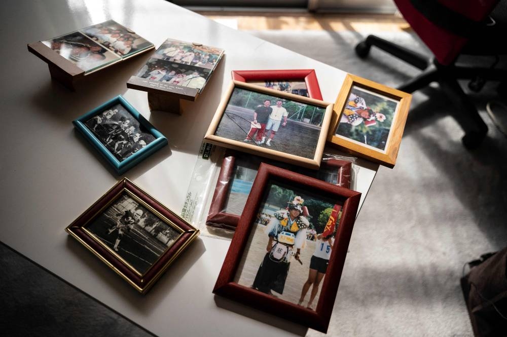 This photo taken on November 24, 2022 shows photos of former Japanese teacher Yoshio Kudo who died in 2007 from 