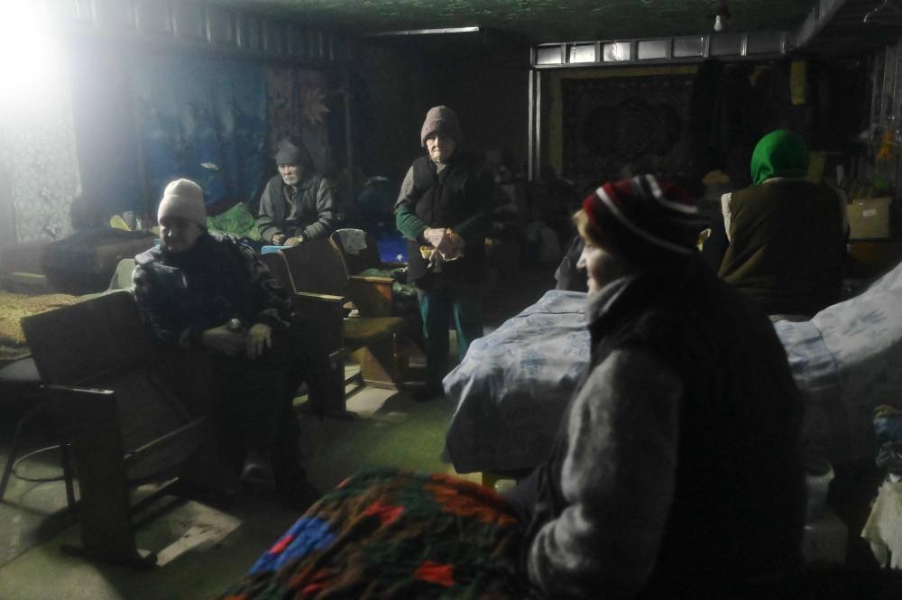 Local residents sit in the basement of residential building, where they live to protect themselves from the bombings, in Avdiivka, Donetsk region on December 15, 2022, amid the Russian invasion of Ukraine. — AFP pic