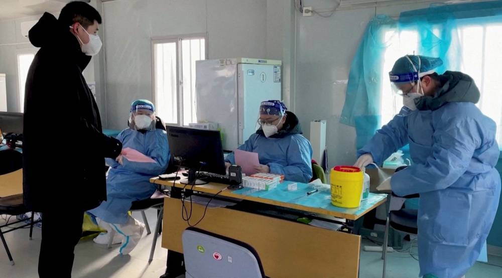 A health worker registers a resident for a nasal spray COVID-19 booster vaccine in Beijing, China December 17, 2022 in this still image obtained from a video. — Reuters TV pic