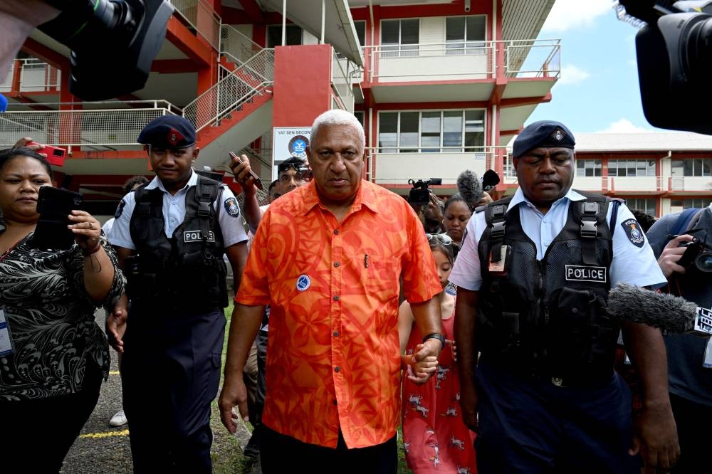 Fiji’s Prime Minister and Fiji First leader Frank Bainimarama leaves after voting at a polling station during the Fijian general election in Suva, Fiji, December 14, 2022. — AAP Image/Mick Tsikas/Reuters pic