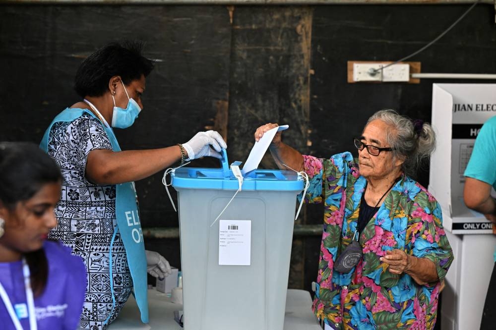 A person votes at a polling station during the Fijian general election in Suva, Fiji, December 14, 2022. — AAP Image/Mick Tsikas/Reuters pic