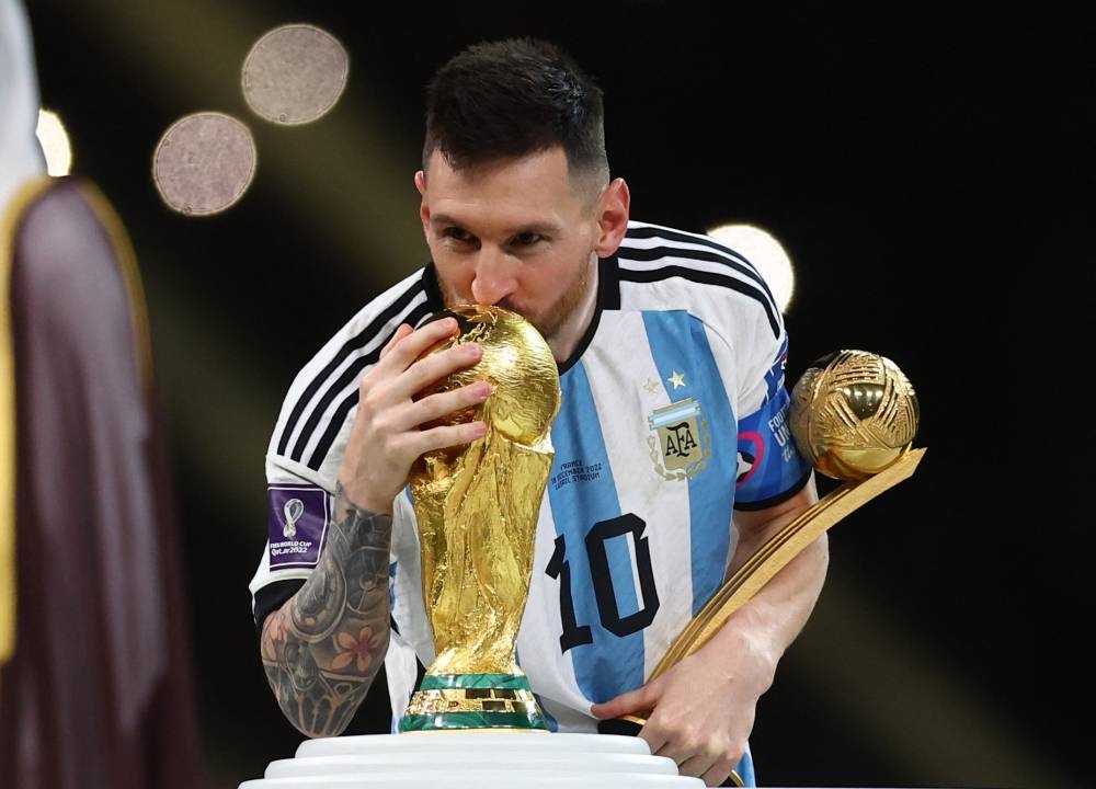 Argentina's Lionel Messi kisses the World Cup trophy after collecting the Golden Ball award after the match against France at the Lusail Stadium December 18, 2022. — Reuters pic