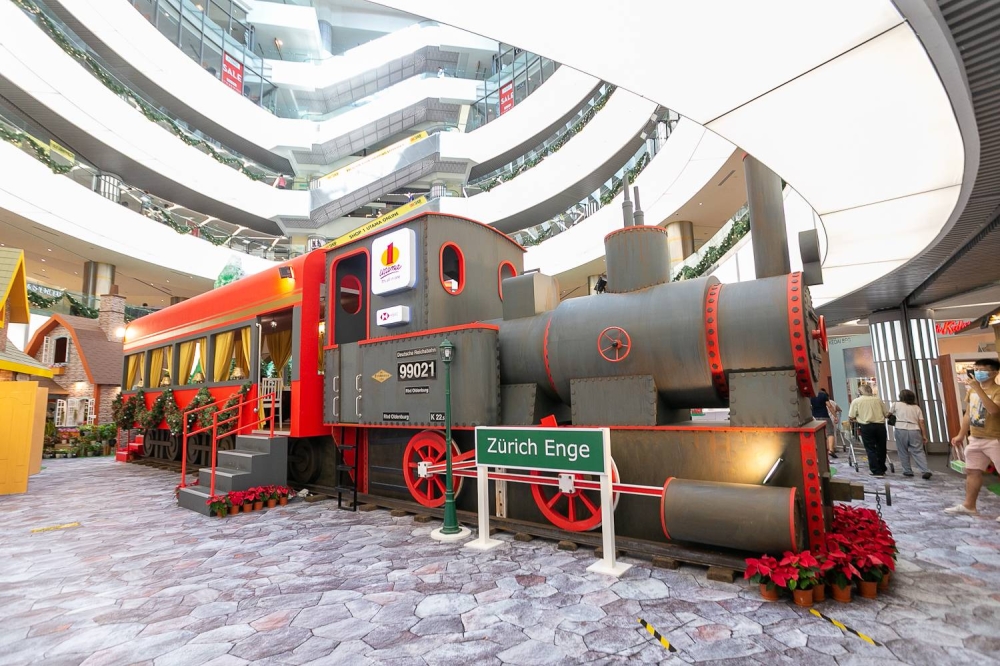 1 Utama Shopping Centre’s Swiss Alps Town Christmas décor features a life-sized British steam train. — Picture by Raymond Manuel