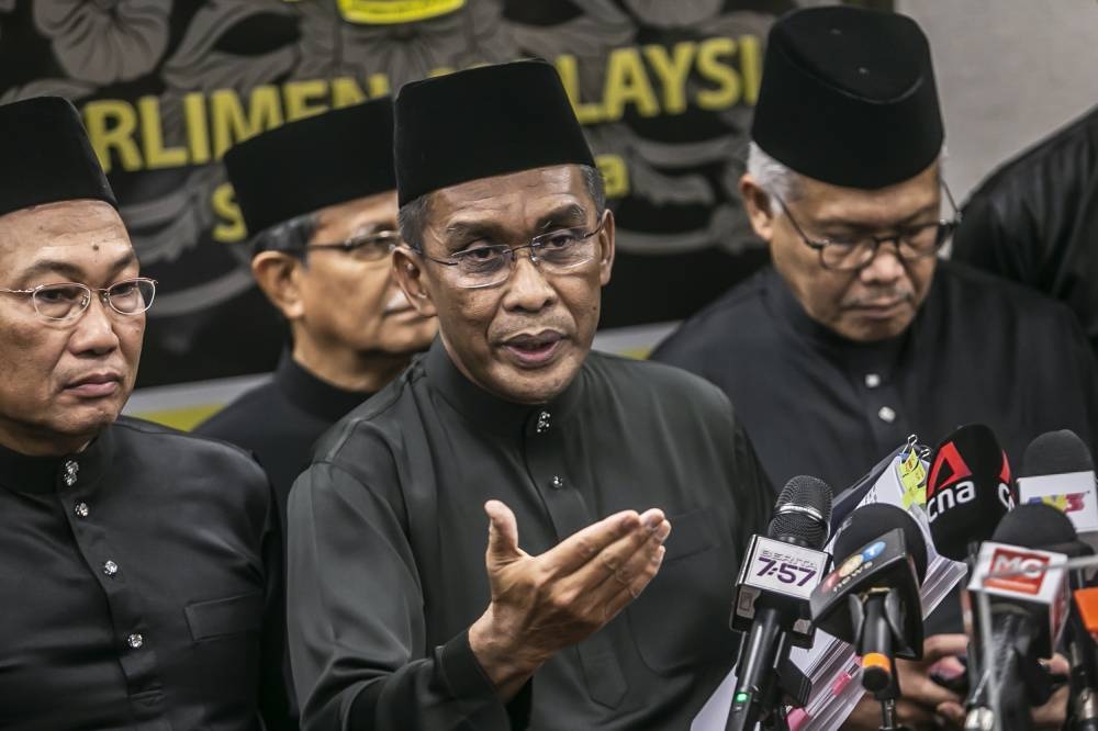 Kota Baru MP Datuk Seri Takiyuddin Hassan (centre) speaks to the media during the press conference after the special parliamentary session at Parliament December 19, 2022. — Picture by Hari Anggara