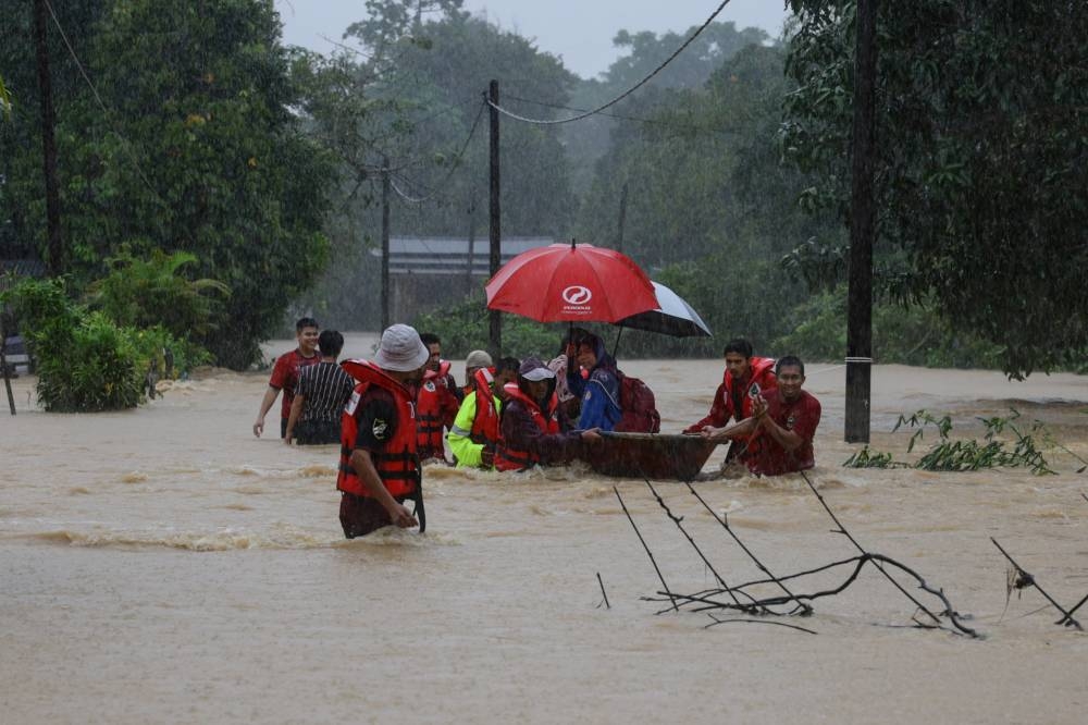 Volunteers help flood victims evacuate at Kampung Buluh Hilir in Bandar Permaisuri December 19, 2022. — Bernama pic