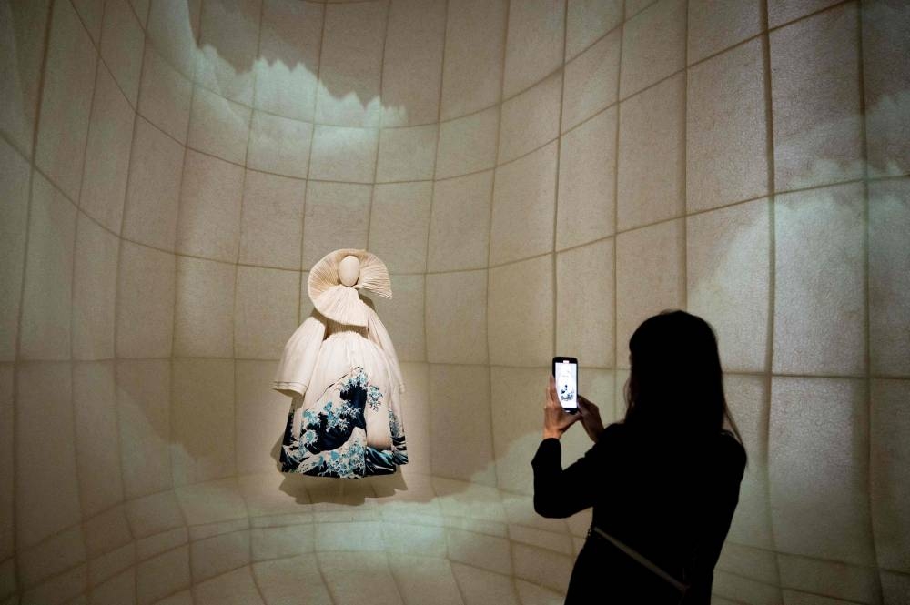 In this picture taken on December 19, 2022, a guest visits the exhibition ‘Christian Dior: Designer of Dreams’ during a media preview at the Museum of Contemporary Art Tokyo in Tokyo. — AFP pic