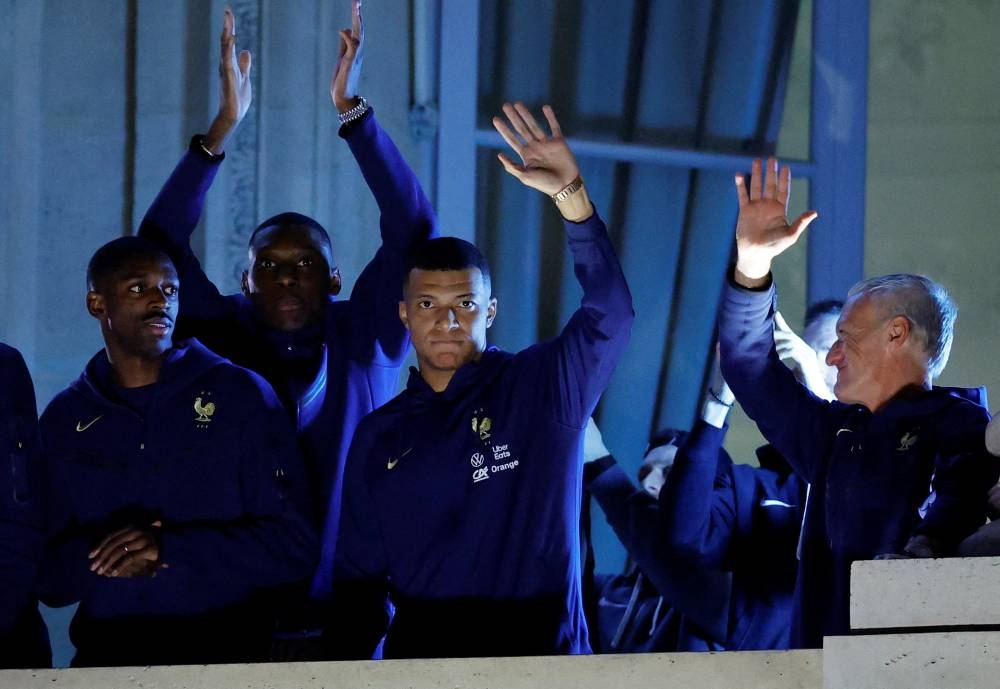 France’s Kylian Mbappe and teammates greet fans from a balcony at Hotel Crillon in Paris, December 19, 2022. — Reuters pic 
